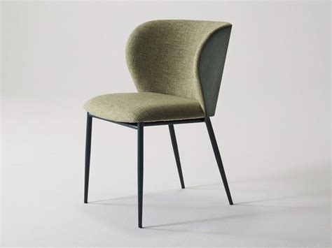 An Upholstered Chair With Black Legs And A Light Green Fabric Seat