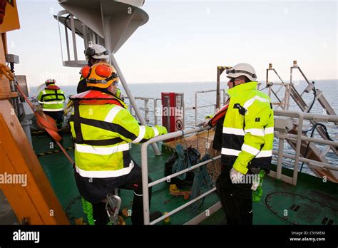 Construction Workers Prepare To Climb Down Onto A Wind Turbine Being