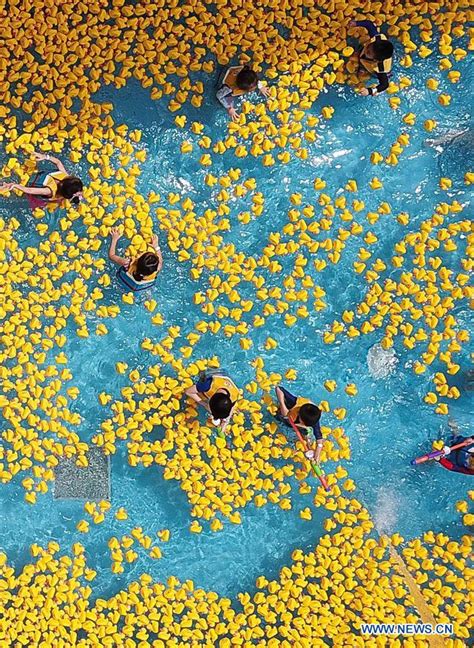 People Have Fun With Yellow Rubber Ducks At Chimelong Water Park In