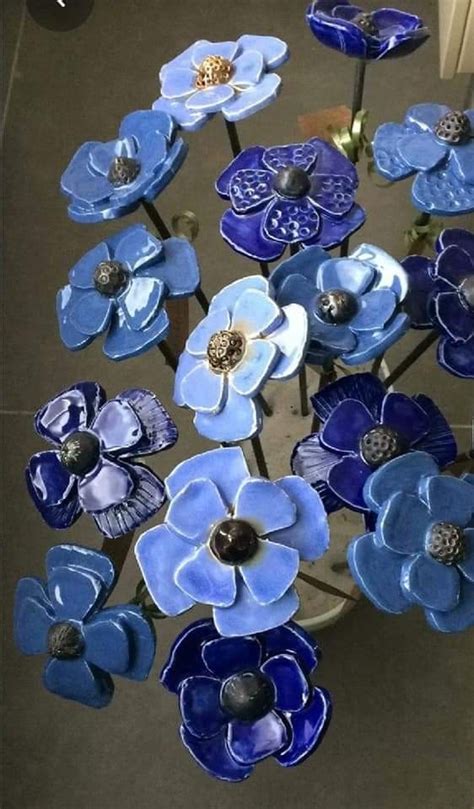 Blue And White Flowers Are Arranged On A Metal Stand In The Middle Of A