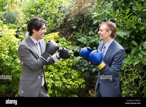 Two young men in suits stage a mock boxing match Stock Photo - Alamy