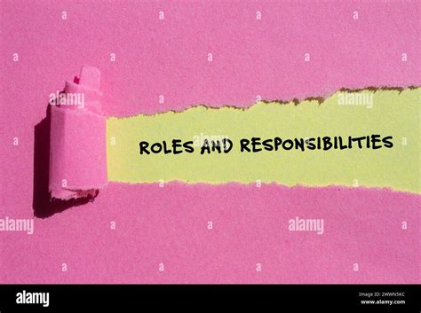 Roles And Responsibilities Words Written On Pink Torn Paper With Yellow