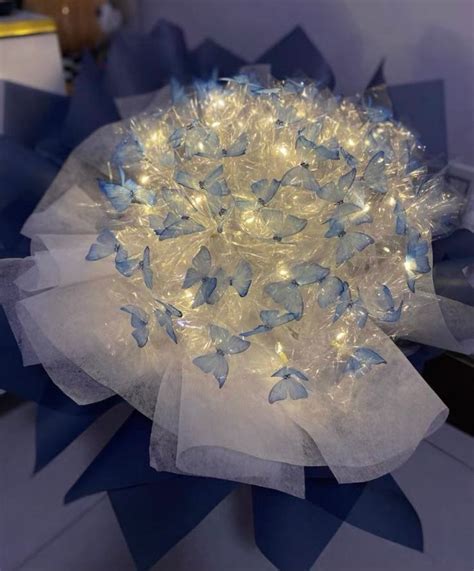 A Blue And White Flower With Lights On It S Petals In The Shape Of