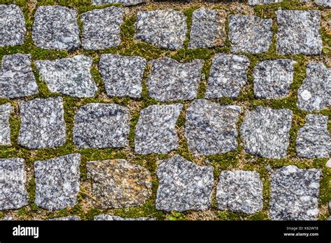 Abstract Background Of Old Cobblestone Pavement Texture With Natural