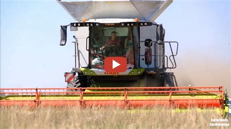 Ein Claas Trion Mit M Vario Schneidwerk Und Ein John Deere