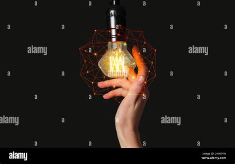 Female Hand And Glowing Light Bulb On Black Background Stock Photo Alamy