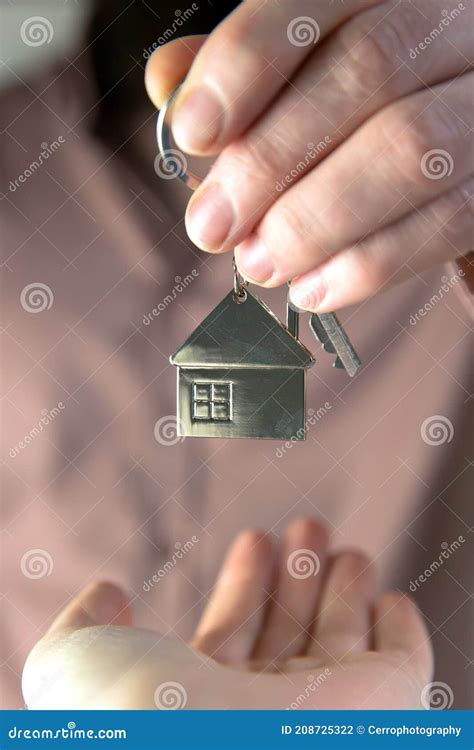 Estate Agent Giving House Keys To Client For New Home Contract Real