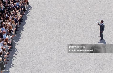 Businessman With Megaphone Talking To Crowd Of People High-Res Stock ...