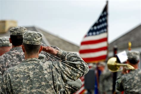 Soldiers Salute The American Flag During The Playing Of The National