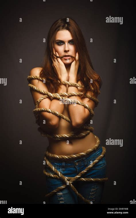 Brunette Woman Bound With Rope Prisoner In Jeans Stock Photo Alamy