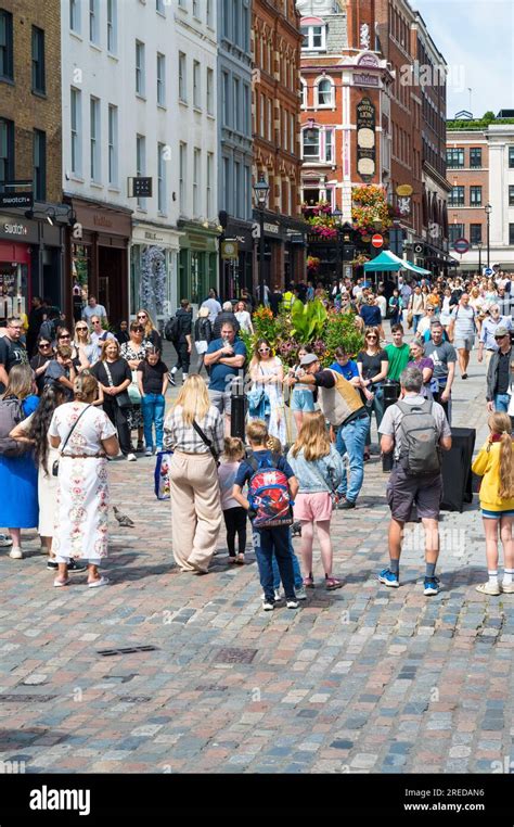 Crowd Of People Gathered To Watch Street Entertainer Covent Garden