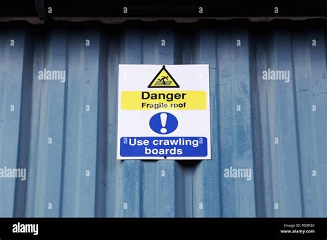 Danger Fragile Roof Use Crawling Boards Warning Sign Stock Photo Alamy