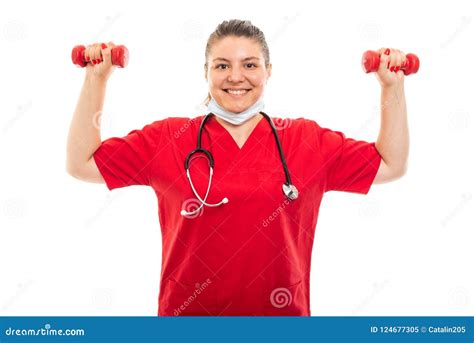 Young Medical Nurse Wearing Red Scrub Lifting Dumbbells Stock Image