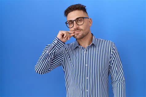 Hispanic Man With Beard Wearing Glasses Mouth And Lips Shut As Zip With