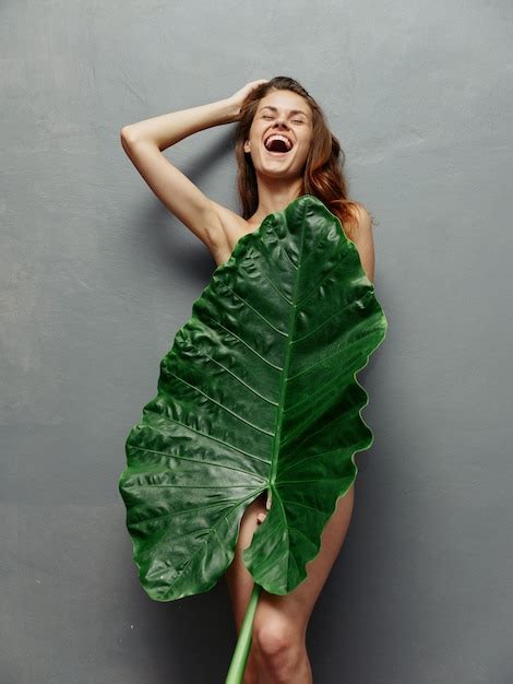 Premium Photo Joyful Woman Hiding Behind Palm Leaf Nude Body Isolated