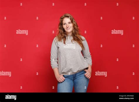 Portrait Of Beautiful Mature Brunette Woman In Grey Sweater And Blue