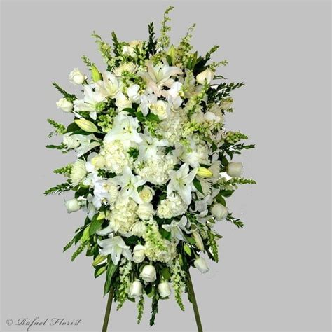 Memorial spray of fragrant white lilies, white orchids, hydrangeas, roses