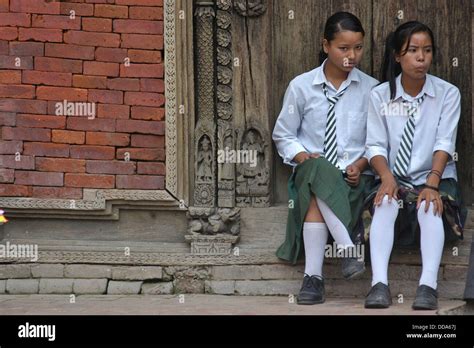 Schoolgirls in uniform sitting in Durbar Square, Patan Stock Photo - Alamy