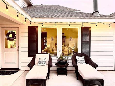 Modern Farmhouse Outdoor Lighting Above Black Rattan Chaises Soul Lane