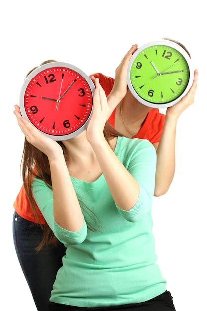 Premium Photo Girls Holding Clocks Over Face Isolated On White