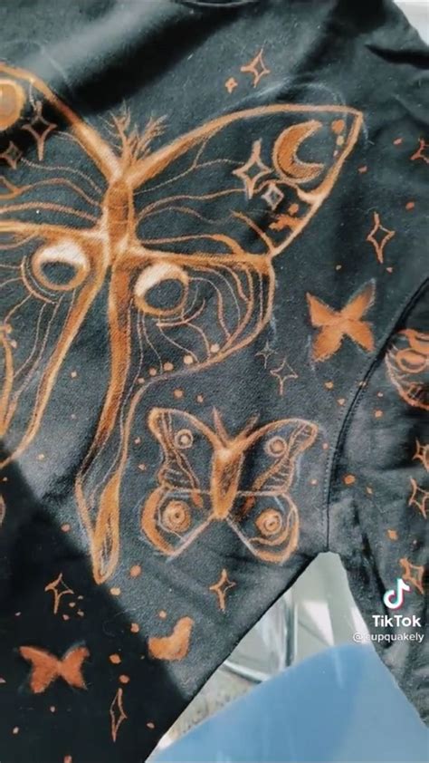 A Close Up Of A Shirt With A Butterfly On It S Chest And Stars Around