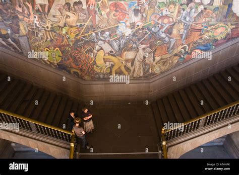 Tourists Standing On The Stairs Of The National Palace Watching The