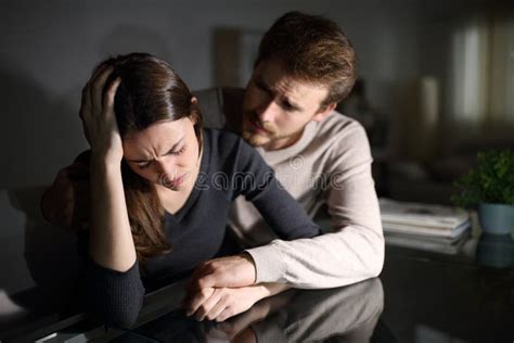 Sad Wife And Husband Comforting Her In The Night At Home Stock Image