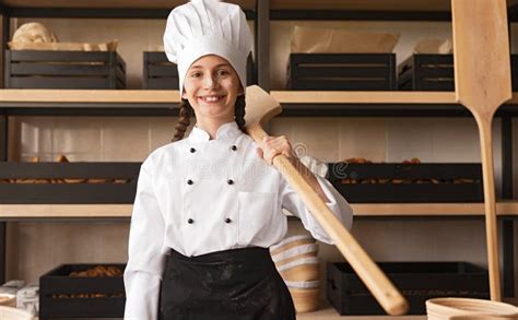 Proud Little Baker in Uniform Holding Wooden Utensil while Standing at ...