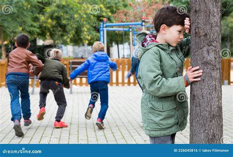 Niño Jugando a La Escondida Con Sus Amigos Foto de archivo Imagen de