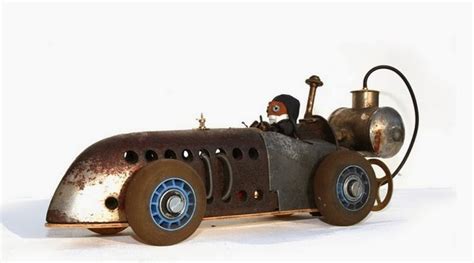 An Old Fashioned Toy Car With A Man Driving It