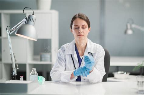 Portrait Of A Cute Woman Doctor In Blue Medical Latex Gloves At The