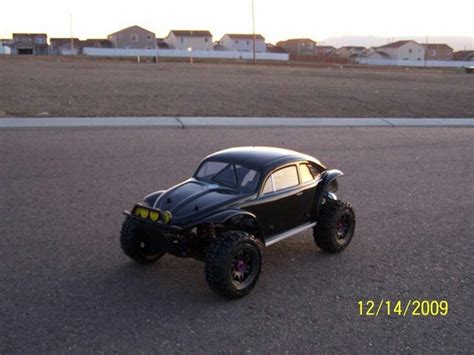 A Toy Car Is Parked In The Middle Of An Empty Lot With No Wheels On It