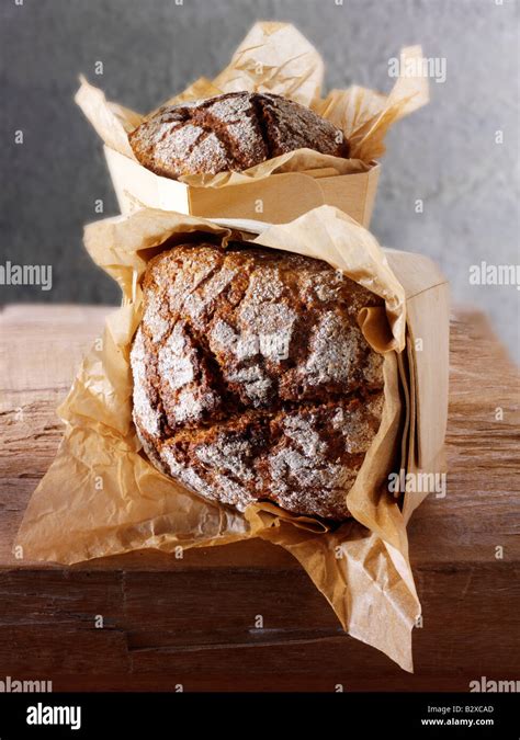 Loaves Of Artisan Rye Bread In A Rustic Setting On A Wood Table Stock