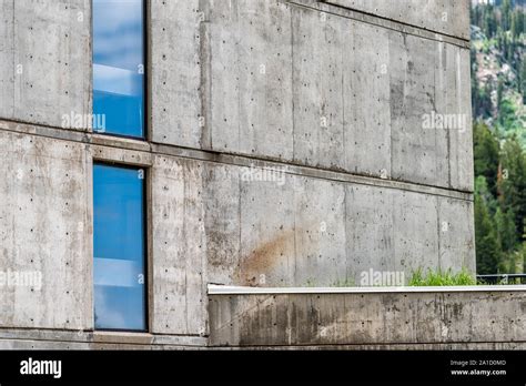 Brutalist architecture with concrete walls and glass windows abstract closeup of building Stock ...