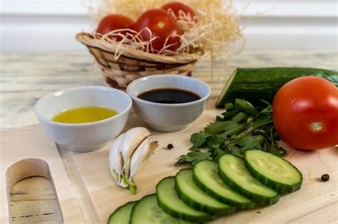 Premium Photo Tomatoes And Cucumbers On The Table Olive Oil And