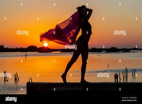 A Beautiful Hispanic Brunette Model Enjoying The Morning Sun At Sunrise