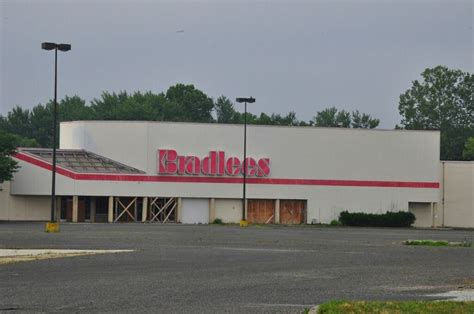 An Empty Parking Lot In Front Of A Building With The Word Baddes On It