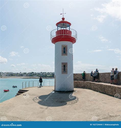 Tourists Visit the Old Port and Lighthouse of Erquy on the Coast of ...