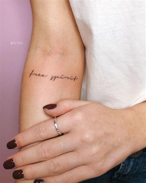 A Woman S Arm With A Small Tattoo On It That Says Free Spirit