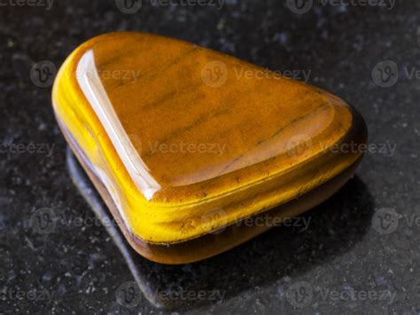 Polished Tiger Eye Gem Stone On Dark Background 14259173 Stock Photo At