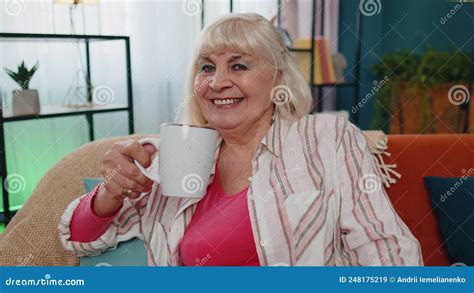 Senior Stylish Old Grandmother Woman Sitting On Couch Relaxing At Home