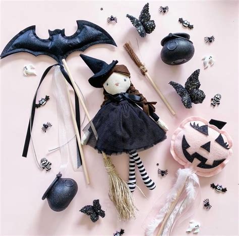 An Assortment Of Halloween Decorations Including A Doll And Bats On A