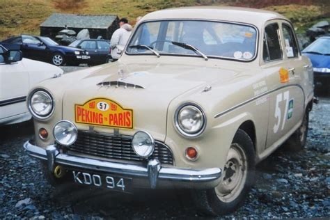 An Old Car Is Parked On The Gravel