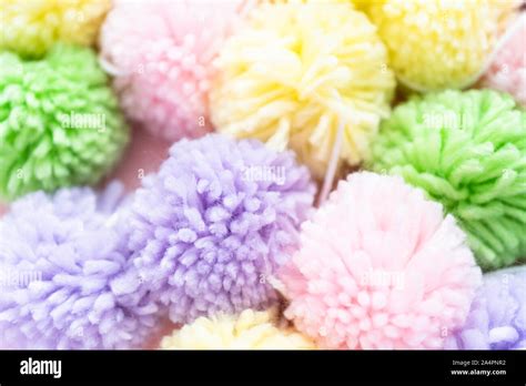 Pastel Color Pom Poms On A Pink Background Stock Photo Alamy