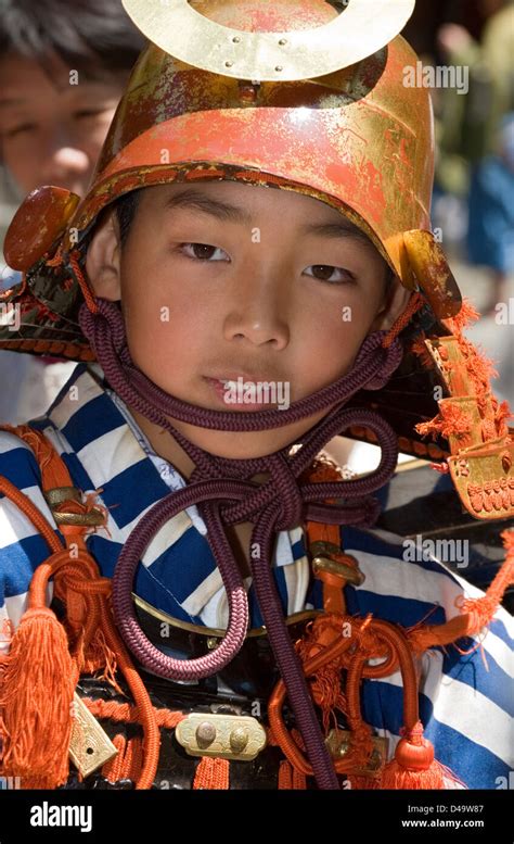 Young Samurai Warrior Dressed In Armor With Helmet Partakes In The