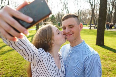 Happy Smiling Couple Taking Selfie Kiss And Take Pictures On Sm Stock