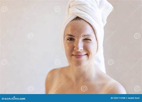 Portrait Of A Cheerful Attractive Woman With A Towel Wrapped Around Her