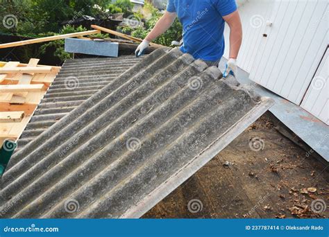 Old Asbestos Cement Roof Removal And Replacement A Roofing Contractor Is Removing Old Asbestos