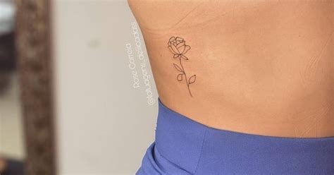 Fine Line Rose Tattoo Located On The Rib