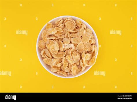 White Plate With Cornflakes For A Delicious Breakfast On A Yellow